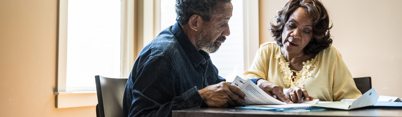 Couple looking at documents on table.